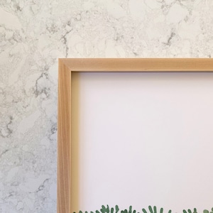 May include: A light wood picture frame with a white mat. The frame is empty and ready for a picture.