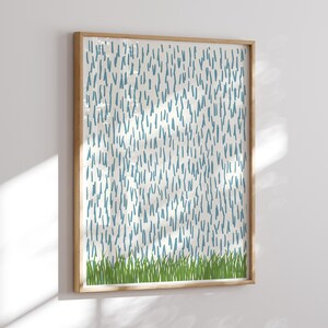 May include: A framed abstract print with a white background and a pattern of blue lines. The bottom of the print features a row of green grass.