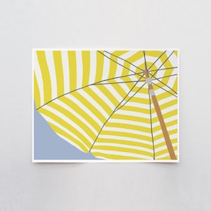 May include: A print featuring a beach umbrella with yellow and white stripes. The wooden pole and black support lines of the umbrella are visible against a light blue backdrop. The artwork is a minimalist, summery design.