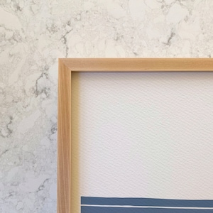 May include: A natural wood frame with a light wood finish. The frame is empty and ready to display a print or photo.
