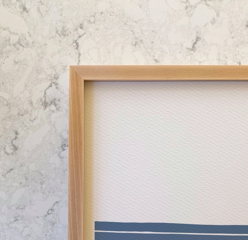 May include: A natural wood frame with a light wood finish. The frame is empty and ready to display a print or photo.