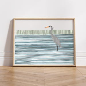 May include: A framed illustration of a gray heron standing in a blue and green striped pattern.