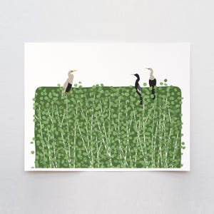 May include: A print featuring three stylized birds perched on a green, leafy hedge. The birds have black, white, and gray plumage with yellow beaks. The background is a solid white, creating a clean and modern aesthetic.