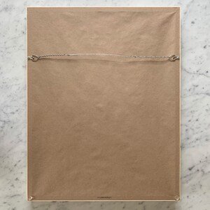 the back of a framed, ready to hang print by artist jorey hurley.  the frame includes a wire across the back for hanging and a kraft paper dust backing to protect the art. felt bumpers are on the bottom corners to protect the wall.