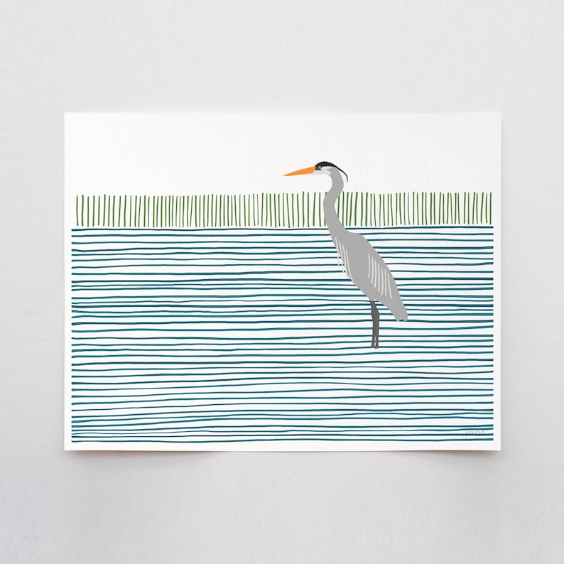 May include: A gray heron with an orange beak stands in a blue and green striped water scene.