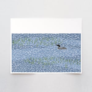 May include: A rectangular art print featuring a stylized illustration of a black and white loon swimming in blue water. The water is depicted with short, horizontal white dashes, and patches of green reeds emerge from the surface.