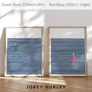 May include: Two framed prints of minimalist nautical illustrations. The left print features a green buoy on a blue and white striped background. The right print features a red buoy on a blue and white striped background. The text "JOREY HURLEY" is printed below the prints.