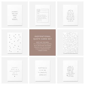 May include: An inspirational quote card set featuring 12 hand-lettered quotes with matching patterns on the reverse side. The set includes a handcrafted timber stand. The cards are white with black text and designs.