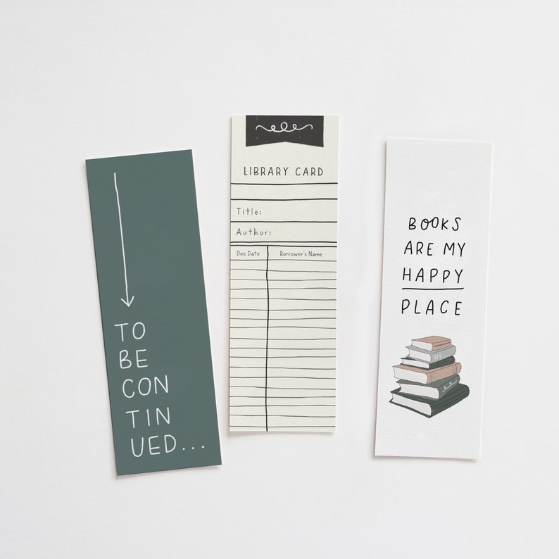 May include: Three rectangular bookmarks. One is teal with the words "TO BE CONTINUED...". Another is a library card design. The third bookmark says "BOOKS ARE MY HAPPY PLACE" with a stack of books. All are on a white background.