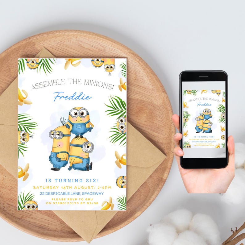 May include: A birthday invitation featuring Minion characters. The invitation reads "Assemble the Minions! Freddie is turning six!" with event details. The design includes banana and palm leaf illustrations, presented on a wooden tray with an envelope and a smartphone displaying the same design.