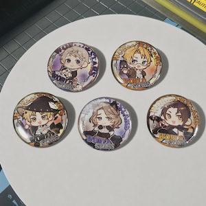 May include: Five circular pin-back buttons featuring chibi-style anime characters. Each button displays the text "WORLD STARS" in a stylized font. The designs include characters with various hair colors and outfits, set against colorful, patterned backgrounds.