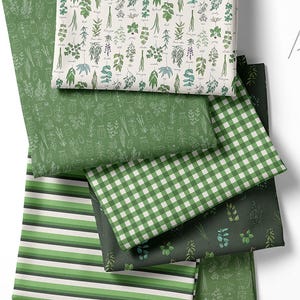 May include: A collection of green fabric swatches with various patterns. Designs include botanical illustrations, stripes, and a gingham check. The fabrics feature shades of green and white, suitable for crafting or home decor projects.