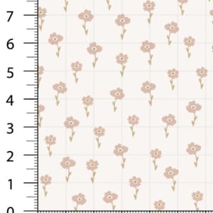 May include: A fabric sample featuring a repeating floral pattern. The design showcases small, light pink flowers with yellow centers and stems, evenly spaced on a cream-colored background. The grid-like pattern is marked with a ruler showing measurements in inches.