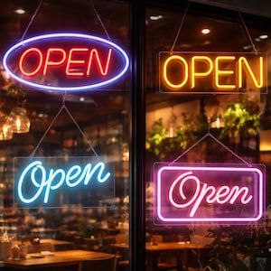 May include: Four neon signs displaying the word "OPEN" hang in a storefront window. The signs are in red, orange, blue, and pink, with various shapes including an oval and rectangles. The signs are lit up, indicating the business is open.