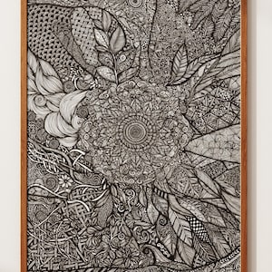 May include: A rectangular framed wall art piece featuring a dense, intricate black and white ink drawing. The artwork displays a central circular mandala pattern surrounded by various detailed textures, including woven lines, leaves, and geometric shapes.