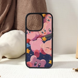 May include: Black phone case featuring a repeating pattern of pink cartoon characters with large eyes and small arms. The background is a dark blue with yellow stars. The case has a black border.