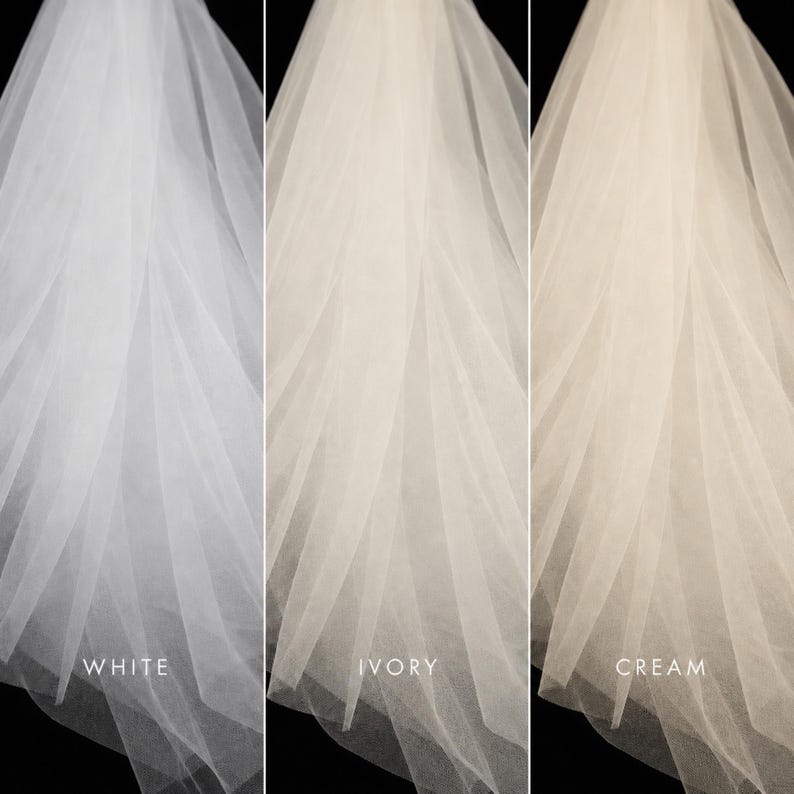 May include: A side-by-side comparison of three sheer tulle veils in different shades. The left veil is labeled WHITE, the center veil is labeled IVORY, and the right veil is labeled CREAM. Each veil features soft, flowing layers of fine fabric.