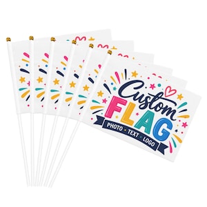May include: A set of six white handheld flags on white plastic poles with gold-colored finials. Each flag features a colorful graphic design with stars, hearts, and fireworks, and the text Custom FLAG PHOTO TEXT LOGO in blue and pink.