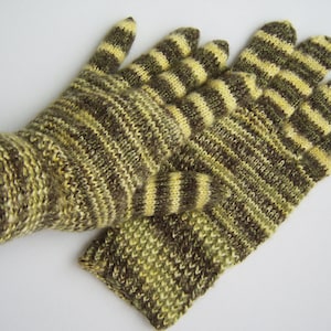May include: A pair of striped knit gloves in brown and yellow. The gloves are made with a soft, textured yarn.