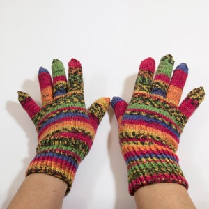 May include: A pair of colorful striped knitted gloves with a multi-colored pattern of red, orange, yellow, green, blue, and black.