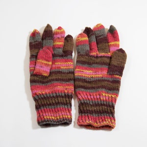 May include: A pair of striped knit gloves in brown, pink, and yellow.