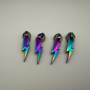 May include: A set of three ceramic mugs with a speckled, matte finish. The mugs are in shades of cream, light gray, and dark gray. Each mug has a simple, minimalist design, perfect for coffee or tea.