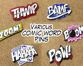 May include: A set of six comic book word pins featuring the words "BAMF", "THWIP", "ZOOM", "POW", "BOOM", and "HAHAHA". The pins are colorful and have a retro comic book style.