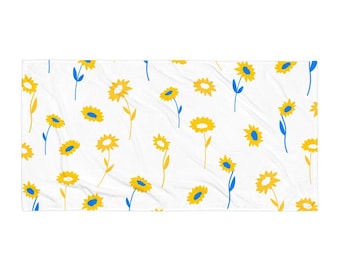 Toalla de rizo de algodón con estampado floral en blanco, azul y amarillo. Suave y acogedora. Imprescindible para la playa. Diseño minimalista. Motivo colorido. Regalo ideal para amantes de las flores.