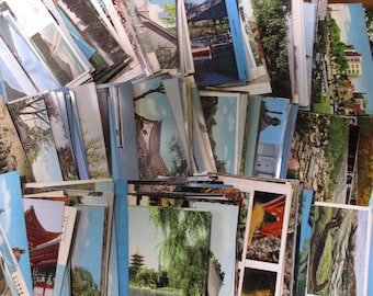 May include: A large collection of vintage postcards featuring various scenes of Japan. The postcards are arranged in a random order, with some showing temples, gardens, and mountains.