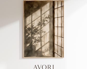 Pode incluir: Uma impressão de arte retangular em uma moldura de madeira clara com uma pintura em aquarela em tons de sépia de uma janela com padrão de grade que projeta sombras longas de galhos com folhas em uma parede. O texto AVORI STUDIO aparece abaixo.