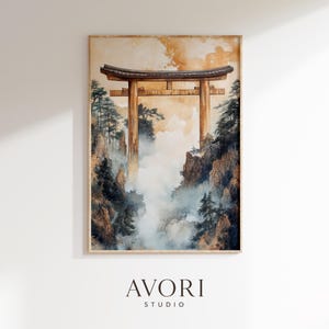 May include: Watercolor painting of a Japanese torii gate set in a misty mountain landscape. The artwork features a warm color palette with shades of brown, beige, and blue. The artwork is framed and has the text "AVORI STUDIO" at the bottom.