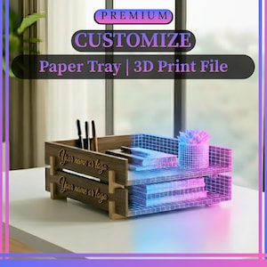 May include: A wooden paper tray with two levels, featuring a pen holder and space for documents. The tray has the text "Your name or logo" and "Customize Paper Tray | 3D Print File". A small plant is on the top shelf.