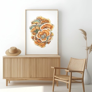 May include: A framed watercolor print of a cluster of orange and blue mushrooms. The artwork is displayed above a wooden cabinet with a straw hat on top. A woven chair and vase with dried plants are also in the room.