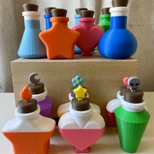 May include: A collection of colorful potion bottles in various shapes, including stars, hearts, and round flasks. Each bottle has a unique design, with different colors and decorative stoppers, such as a skull, a crescent moon, and a flower.