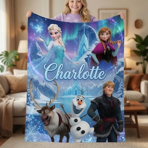 May include: A soft fleece blanket featuring a vibrant Frozen movie theme with characters Elsa, Anna, Kristoff, Sven, and Olaf against a snowy mountain backdrop with the name Charlotte printed in a large, elegant blue script font across the center.
