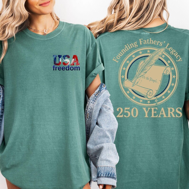 A woman wearing a green t-shirt with the text "USA freedom" and "Founding Fathers' Legacy" printed on it, along with a graphic of a feather and a scroll.