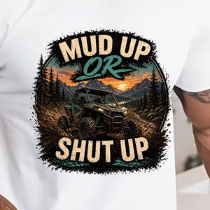 May include: White t-shirt with the text "MUD UP OR SHUT UP" and an off-road vehicle graphic set within a mountain and forest scene. The design includes the text "Instant Download PNG FILE" and a "Hi-Res PNG" graphic.