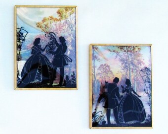 Pair of reverse painted bubble glass silhouettes with romantic scenes