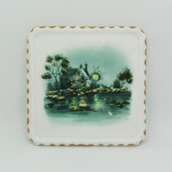 Antique ceramic trivet, c.1900 trivet with hand painted scene of house on a lake