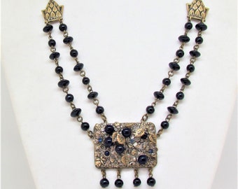 1930's Art Deco festoon necklace with dark blue glass beads and central plaque with 3-D flowers and leaves