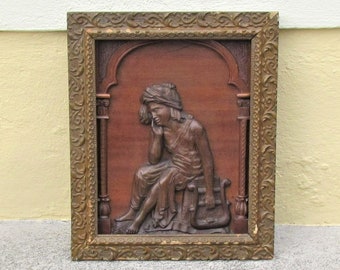 Framed antique carved wooden panel depicting a woman with a lyre