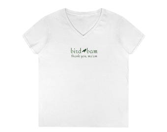 May include: White V-neck t-shirt with the text "bird bam thank you, ma'am" in green. The text is in a handwritten style font. The shirt is made of a soft material.