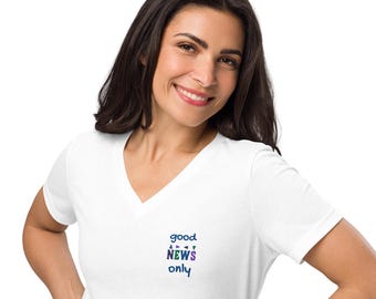May include: White V-neck t-shirt with the text "good NEWS only" in a colorful design. The text is in a mix of blue, purple, and green colors. The shirt is made of a soft material.