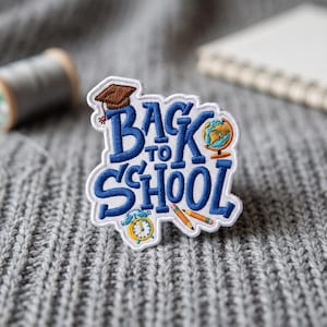 May include: An embroidered patch featuring the text BACK TO SCHOOL in blue thread. The design includes a brown graduation cap, a small globe, a yellow alarm clock, and two pencils in orange and yellow, all outlined in white on a fabric base.
