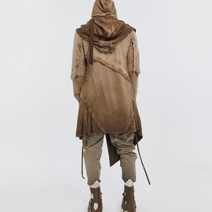 May include: A brown hooded coat with a layered design, paired with matching pants and boots. The coat features a draped front and asymmetrical hem. The outfit is in shades of brown, creating a cohesive, earthy aesthetic.