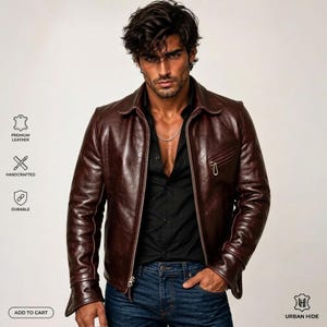 K&ouml;nnte beinhalten: Eine dunkelbraune Lederjacke mit klassischem Kragen, Frontrei&szlig;verschluss und einer Brusttasche mit Rei&szlig;verschluss. Die Jacke wird &uuml;ber einem schwarzen Hemd mit Knopfleiste und einer blauen Jeans getragen. Das Design hat lange &Auml;rmel und eine glatte Oberfl&auml;che.