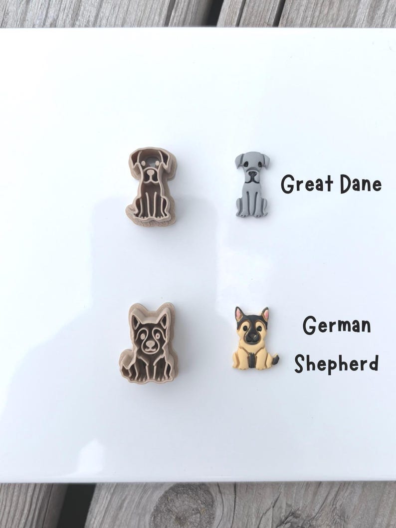 Two labeled dog breed polymer clay cutters and matching clay cutouts showing Great Dane and German Shepherd designs.