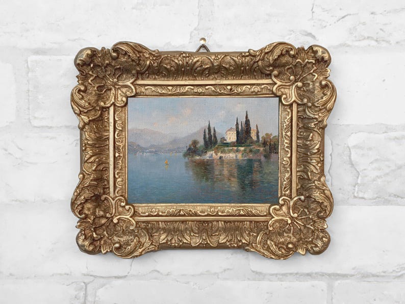 Framed vintage-style canvas print of a serene landscape painting by Emilie Mediz-Pelikan, showing Villa Cipressi overlooking Lake Como, with tall cypress trees, terraced stone walls, and still blue water, all set in an ornate gold antique-style frame.
