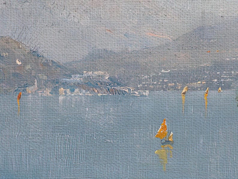 Close up of canvas print showing the lake with sail boats and mountains in the distance.