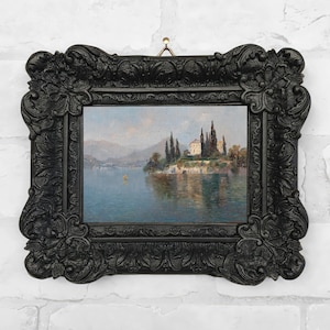 Framed vintage-style canvas print of a serene landscape painting by Emilie Mediz-Pelikan, showing Villa Cipressi overlooking Lake Como, with tall cypress trees, terraced stone walls, and still blue water, all set in an ornate black antique-style frame.